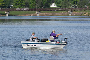 People in a boat casting a line