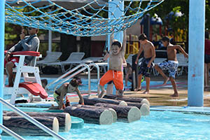 Boys on net course in the swimming pool